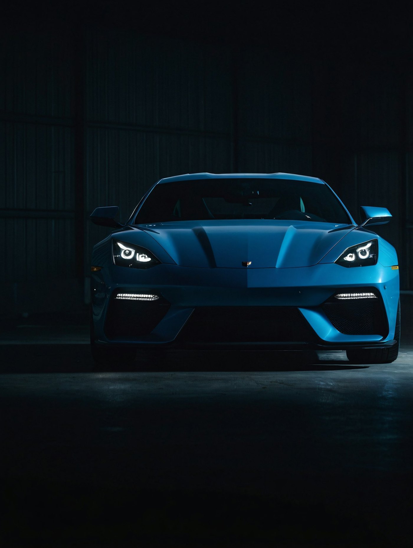 Sports car lit in a dark garage
